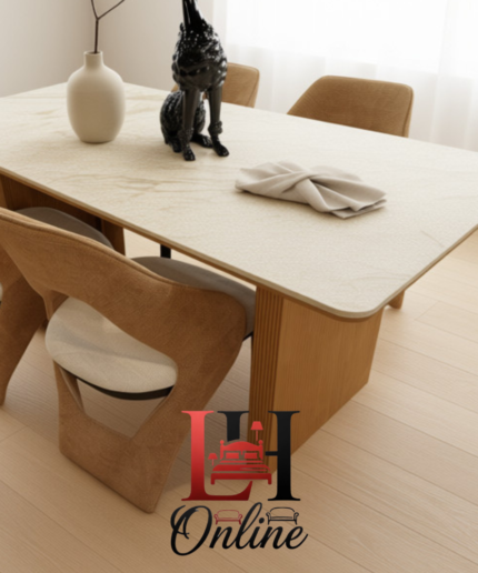 White marble dining table with gold fluted pedestal base and four tan designer chairs.