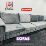 Silver velvet corner sofa with chrome arm details and fluted base tufting