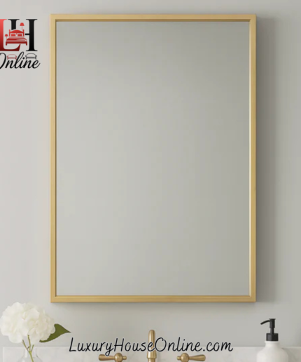 Simple rectangular gold bathroom vanity mirror above sink.