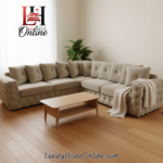 Custom‑size grey tufted L‑shaped corner sofa in a modern living room with light wood flooring, coffee table, floor lamp, and indoor plant.”