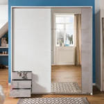 Emden sliding door wardrobe with mirror and grey drawers in a modern bedroom.